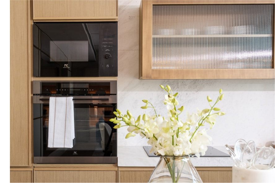 Kitchen with integrated ovens and marble splashback